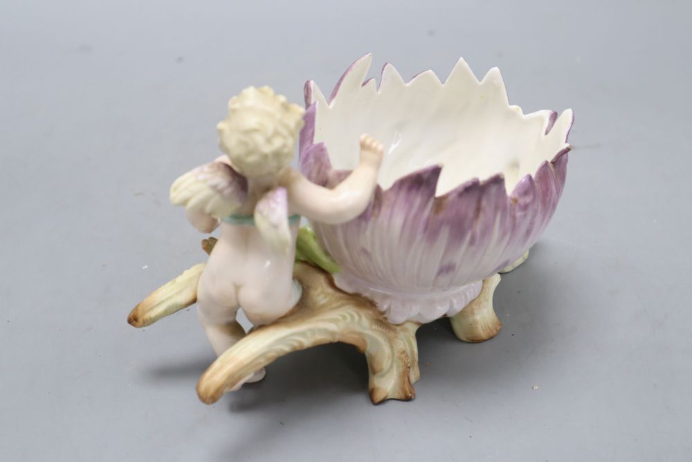 A pair of Augustus Rex floral encrusted porcelain vases and covers and a similar putti centrepiece, tallest 37cm